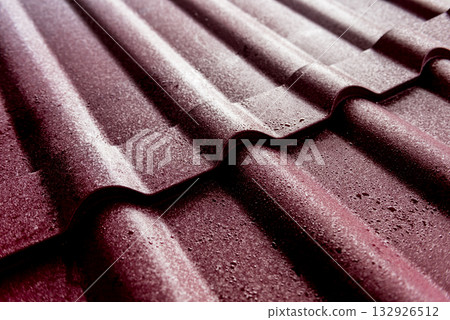 Red metallic roof tiles background with drops of water. Red metallic roof tiles background with drops of water. 132926512