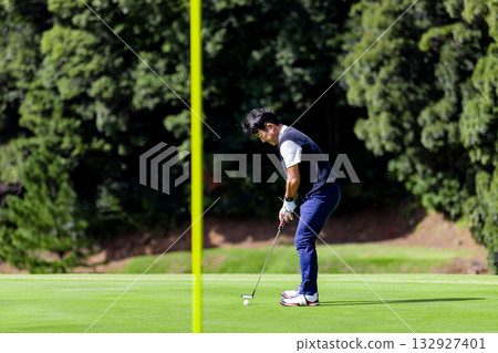 A middle-aged Japanese man enjoying golf A middle-aged Japanese man enjoying golf 132927401