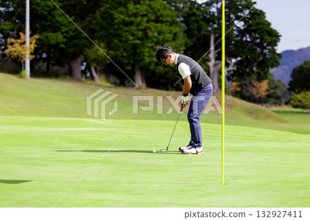 A middle-aged Japanese man enjoying golf A middle-aged Japanese man enjoying golf 132927411