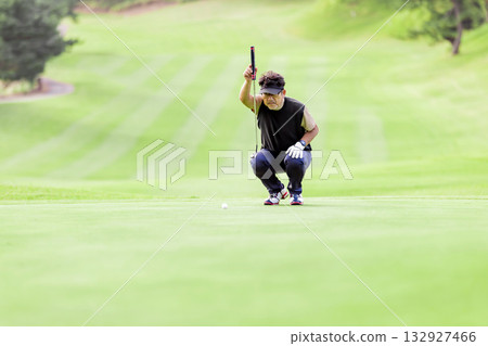 A middle-aged Japanese man enjoying golf A middle-aged Japanese man enjoying golf 132927466