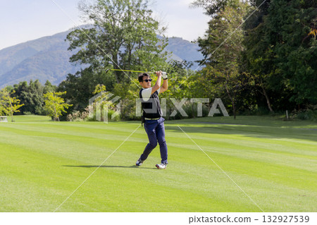 A middle-aged Japanese man enjoying golf A middle-aged Japanese man enjoying golf 132927539