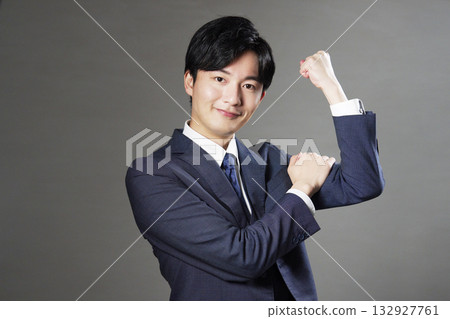 Businessman fist pump black background 132927761
