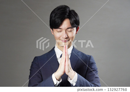 Businessman praying black background Businessman praying black background 132927768