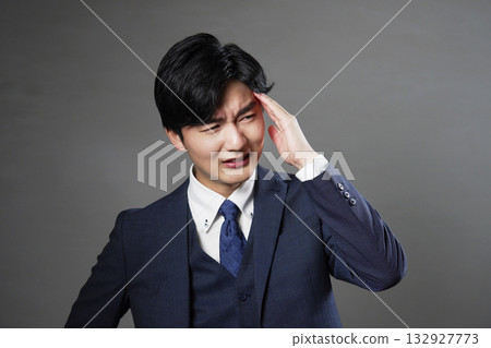 Businessman headache black background 132927773