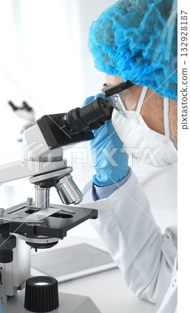 Male senior scientific researcher calibrating precision microscope while examining sample, exploring breakthrough medical research in sterile laboratory setting. Medicine and science concept Male senior scientific researcher calibrating precision microscope while examining sample, exploring breakthrough medical research in sterile laboratory setting. Medicine and science concept 132928187