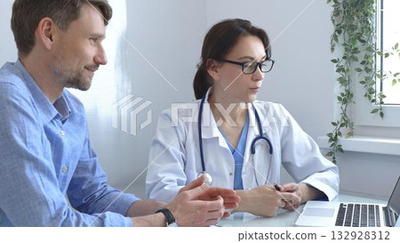 Female doctor explaining a diagnosis to a male patient, offering medical advice and support during a consultation in her office, fostering communication and trust. Medicine and health care Female doctor explaining a diagnosis to a male patient, offering medical advice and support during a consultation in her office, fostering communication and trust. Medicine and health care 132928312