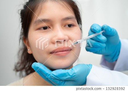 Asian woman receiving filler beauty injection. Asian woman receiving filler beauty injection. 132928392