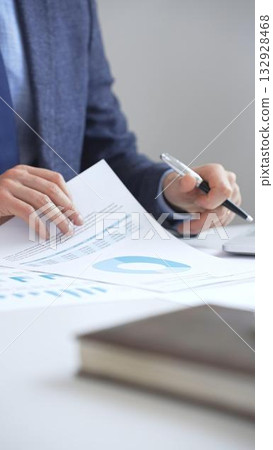 Professional analyzing financial charts on laptop, reviewing data for strategic business planning and investment optimization. Business people concept 132928468