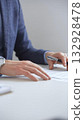 Businessman reviewing contract details, professional hands examining document before signing crucial business agreement in corporate setting. Business people concept 132928478
