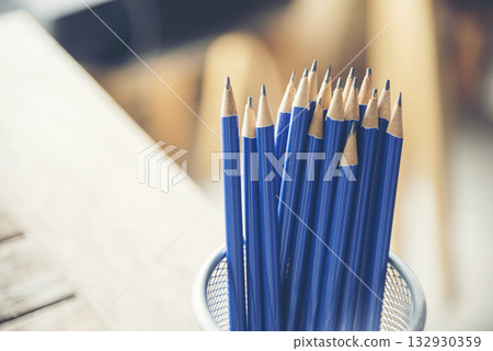 Banner sharp HB pencil vase office supply decor on wood table. Green decorate home office desk. Banner Wood office desk sharpen blue 2B pencil box home office decorate table with copy space 132930359