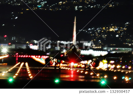 Silhouette of a passenger plane standing on a runway at night 132930457