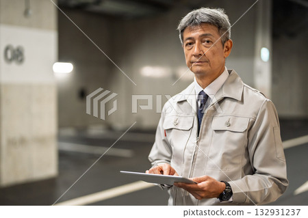Middle-aged man operating a tablet 132931237