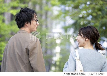 Smiling men and women in their 30s walking down the street Smiling men and women in their 30s walking down the street 132931285