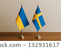 Ukrainian and Swedish flags lined up on a desk 132931617