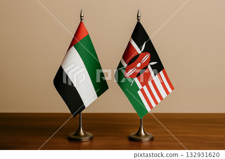 The United Arab Emirates and Kenyan flags are lined up on a desk 132931620
