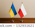 Ukrainian and Polish flags lined up on a desk 132931621