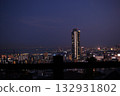 High-rise tower apartments illuminating the city at night and a panoramic seaside night view High-rise tower apartments illuminating the city at night and a panoramic seaside night view 132931802