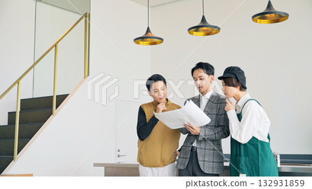 Store staff, designers, and workers meeting at a store facility 132931859