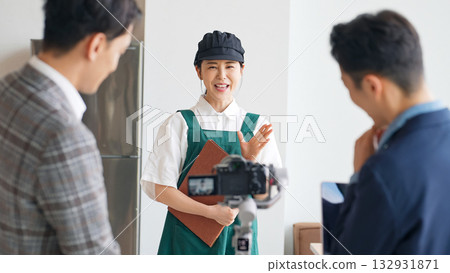 Restaurant staff and filming staff filming a promotional video inside the restaurant Restaurant staff and filming staff filming a promotional video inside the restaurant 132931871
