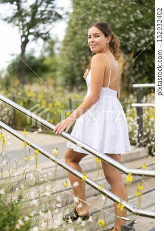 Young woman walks around the city and climbs the stairs Young woman walks around the city and climbs the stairs 132932402