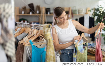 Adult woman choosing summer clothes in store Adult woman choosing summer clothes in store 132932437