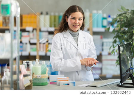 Female pharmacist invites to pharmacy Female pharmacist invites to pharmacy 132932443