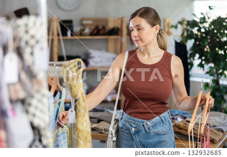 Adult woman choosing summer clothes in store 132932685