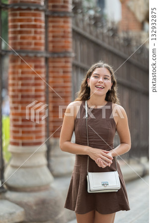 Young female tourist dressing in dress enjoying walk near columns of architectural complex of Hospital de la Santa Creu i Sant Pau in Barcelona 132932875