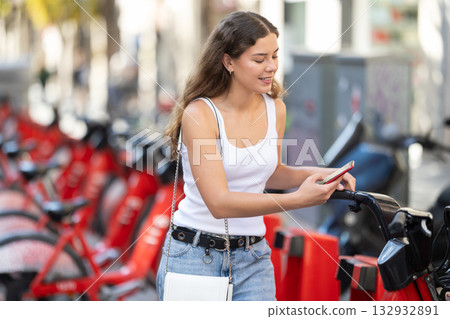 Girl tourist rents bicycle 132932891