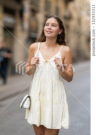 Young woman in white dress walking along the streets of the historical center of city Young woman in white dress walking along the streets of the historical center of city 132933311