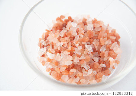 Pink rock salt in a small glass dish Pink rock salt in a small glass dish 132933312
