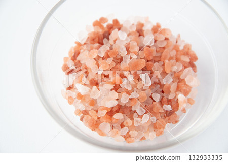 Pink rock salt in a glass container Pink rock salt in a glass container 132933335