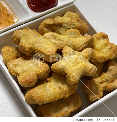 Crispy golden nuggets with a juicy, tender center, offering a perfect bite of savory flavor and satisfying crunch in every delicious, snackable piece. Crispy golden nuggets with a juicy, tender center, offering a perfect bite of savory flavor and satisfying crunch in every delicious, snackable piece. 132933781