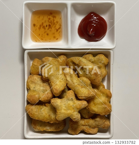 Crispy golden nuggets with a juicy, tender center, offering a perfect bite of savory flavor and satisfying crunch in every delicious, snackable piece. 132933782