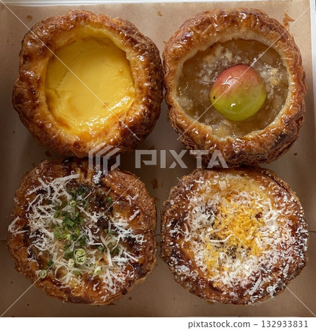 Buttery and flaky egg tart filled with smooth custard and topped with fresh fruits. A perfect blend of creamy sweetness and fruity freshness for a delightful and elegant dessert. 132933831