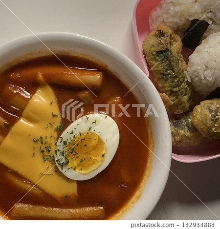 Spicy tteokbokki with chewy rice cakes in a rich, flavorful sauce, paired with crispy twigim for the perfect Korean street food combo. A delicious mix of spicy, crunchy, and savory flavors! Spicy tteokbokki with chewy rice cakes in a rich, flavorful sauce, paired with crispy twigim for the perfect Korean street food combo. A delicious mix of spicy, crunchy, and savory flavors! 132933883