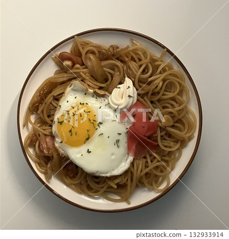 A plate of spaghetti pasta, perfectly cooked and topped with rich marinara sauce and fresh herbs. Ideal for food photography and menus, capturing the heart of Italian cuisine in a delicious way. 132933914