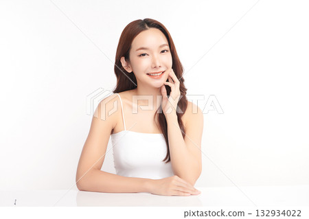 A beautiful young Asian woman with clean, fresh skin against a white background. Skincare, facial treatment, cosmetology, beauty, and spa. An elegant portrait of an Asian woman. 132934022