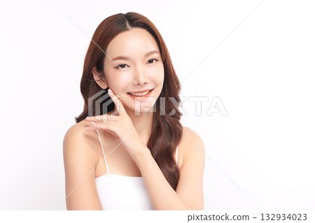 A beautiful young Asian woman with clean, fresh skin against a white background. Skincare, facial treatment, cosmetology, beauty, and spa. An elegant portrait of an Asian woman. 132934023