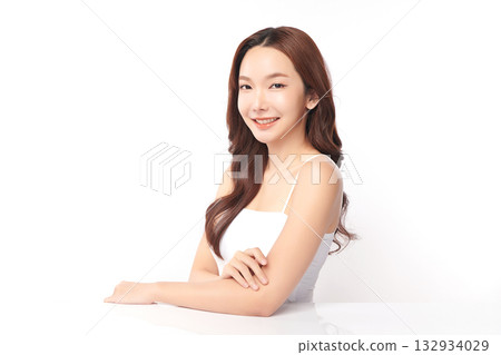 A beautiful young Asian woman with clean, fresh skin against a white background. Skincare, facial treatment, cosmetology, beauty, and spa. An elegant portrait of an Asian woman. 132934029