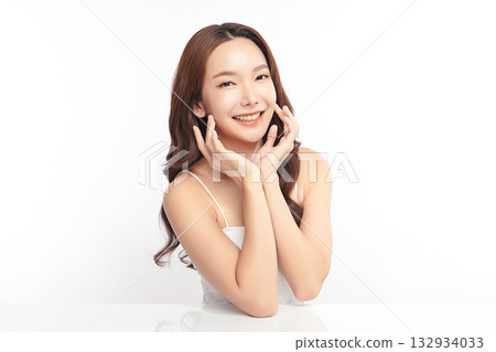 A beautiful young Asian woman with clean, fresh skin against a white background. Skincare, facial treatment, cosmetology, beauty, and spa. An elegant portrait of an Asian woman. A beautiful young Asian woman with clean, fresh skin against a white background. Skincare, facial treatment, cosmetology, beauty, and spa. An elegant portrait of an Asian woman. 132934033