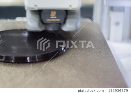 3D printer close up. Working 3D printer in process of printing object from molten black plastic. 3D printer creating model by flowing liquid plastic from extruder of printer. 3D printing technology 3D printer close up. Working 3D printer in process of printing object from molten black plastic. 3D printer creating model by flowing liquid plastic from extruder of printer. 3D printing technology 132934879