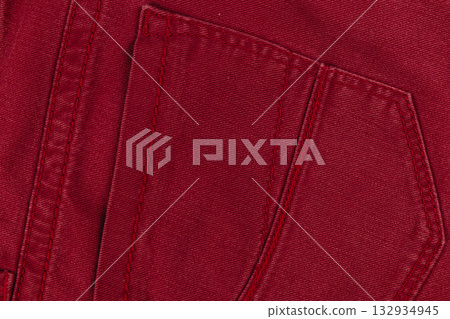 Close-up of red fabric with detailed stitching on pocket design 132934945