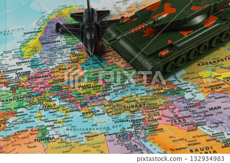 Military toys placed on a map highlighting Europe and Asia 132934983