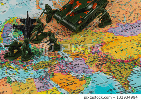 Toy soldiers and vehicles positioned on a world map represent strategic fun Toy soldiers and vehicles positioned on a world map represent strategic fun 132934984