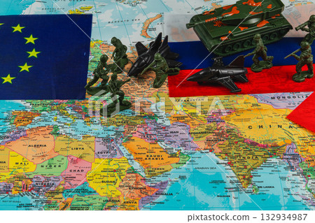 Toy soldiers and vehicles on a map of Europe and Asia 132934987