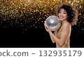Woman joyfully hugs a disco ball with confetti, created AI 132935179