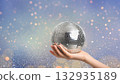 Hand holding disco ball with sparkling lights, created AI 132935189