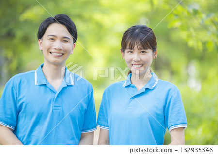 Male and female staff in blue polo shirts 132935346