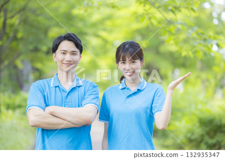 Male and female staff in blue polo shirts 132935347